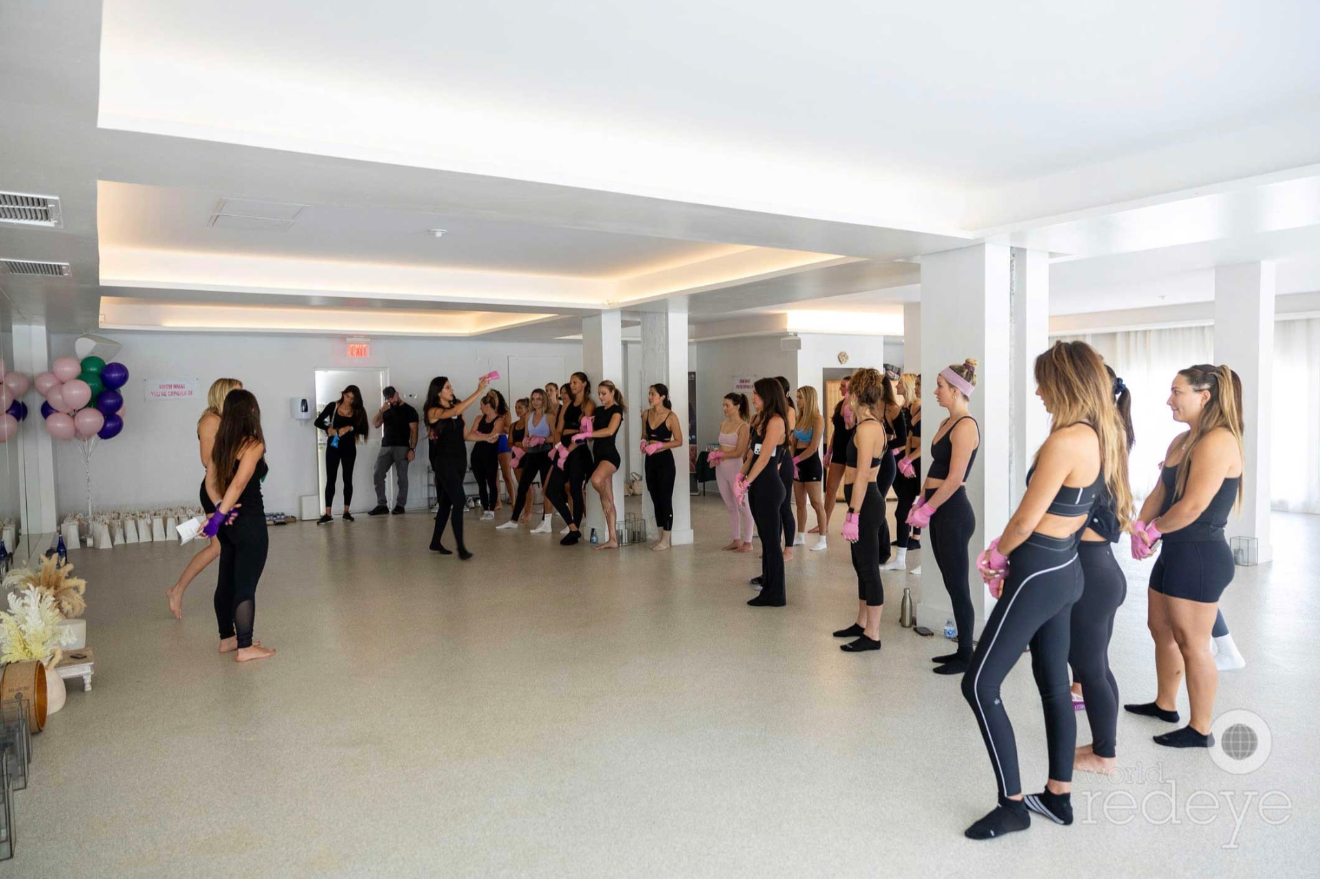 The group stands in a wide circle in the Miami Beach studio, ready for the afternoon.