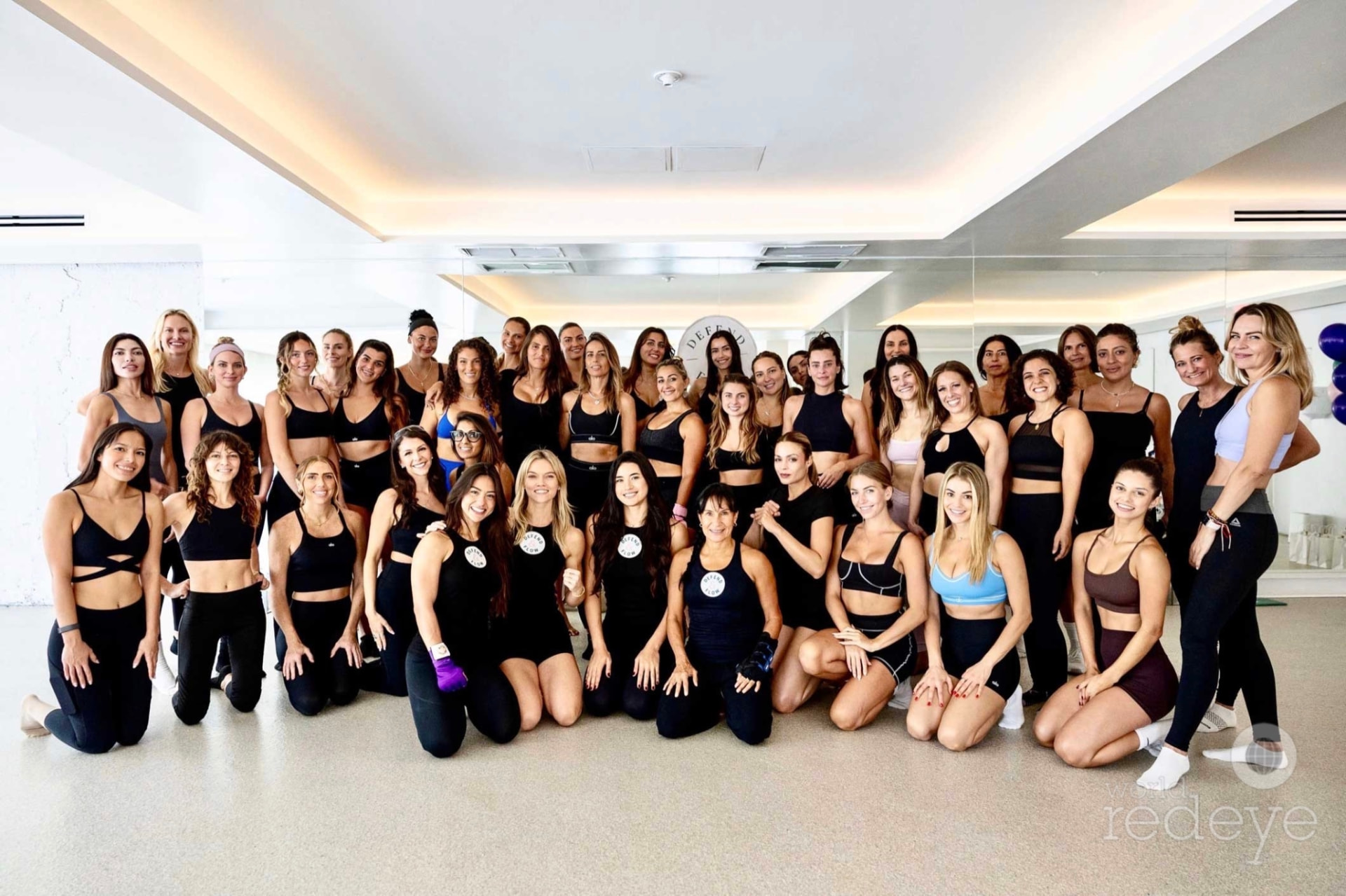 The full group of attendees gathers for a celebratory photo in the studio.